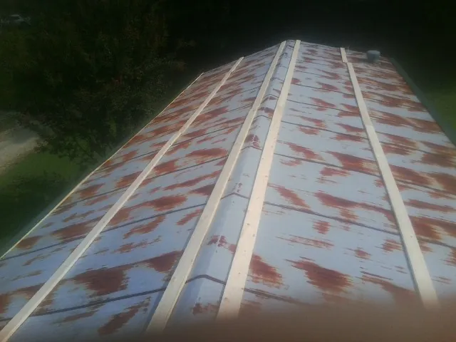 Rusted metal roof panels with new wood purlins before replacement — Storm Damage Roof Repair in Old Hickory by Roofing Brothers