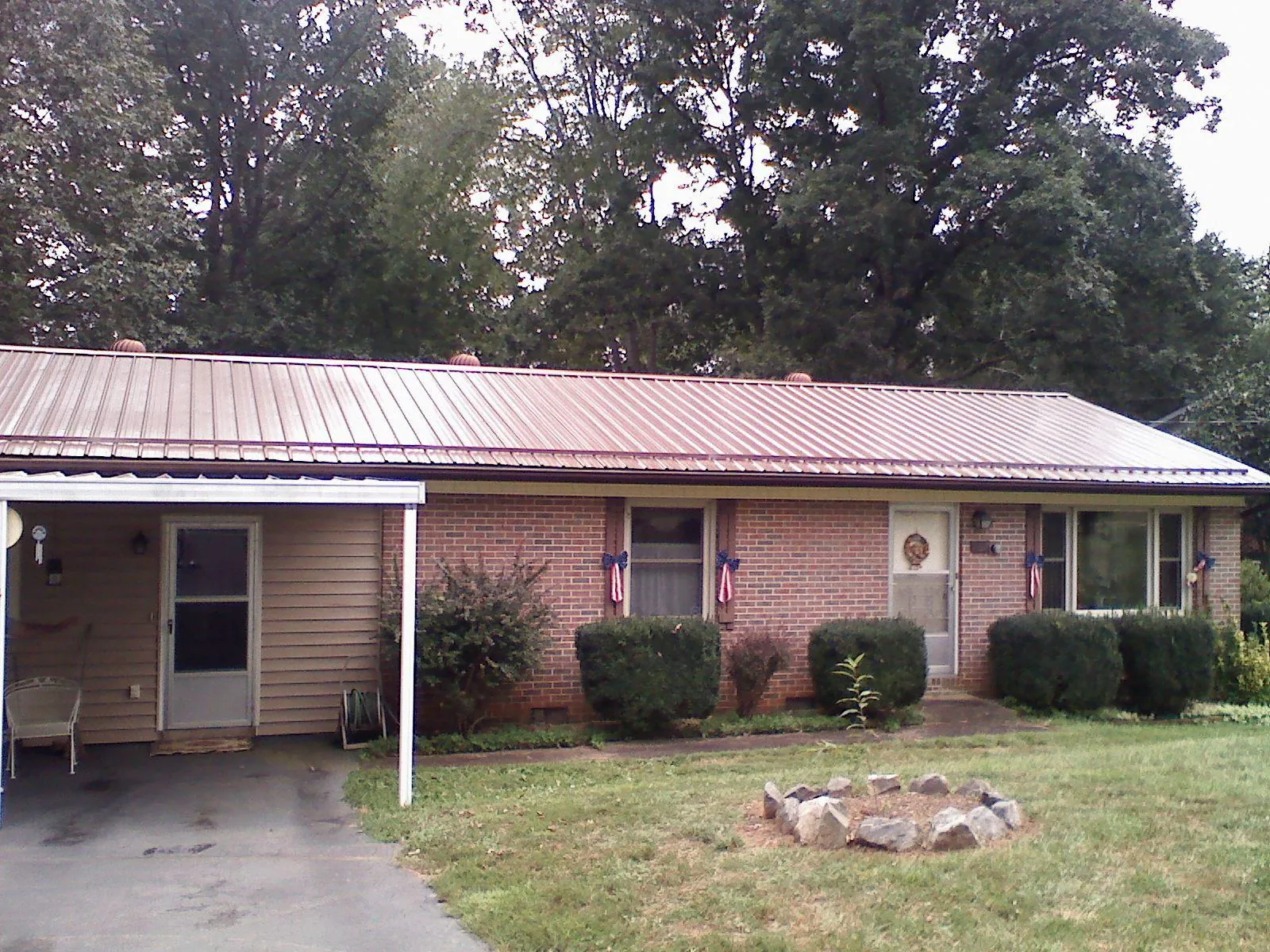 Bronze metal roof and carport on a brick ranch home — Roof Repair work by our crew in Old Hickory