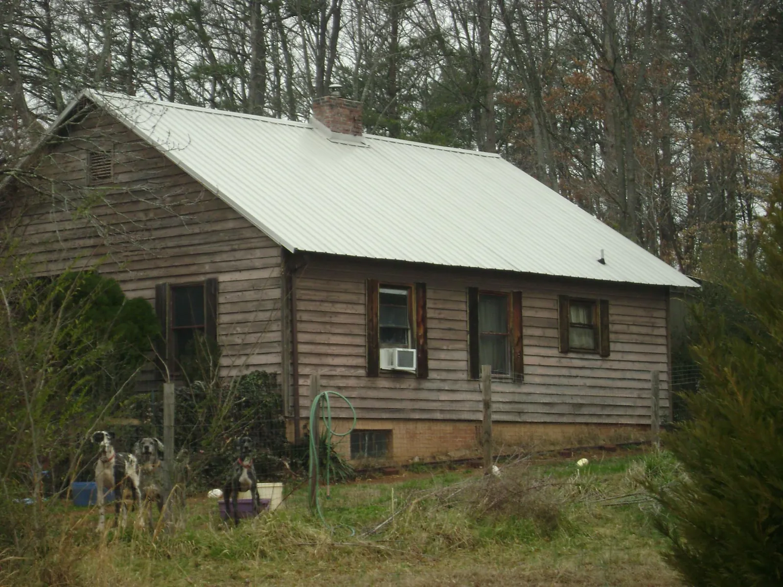 White metal roof on an old wood sided farmhouse, from a Metal Roof Installation job in Old Hickory